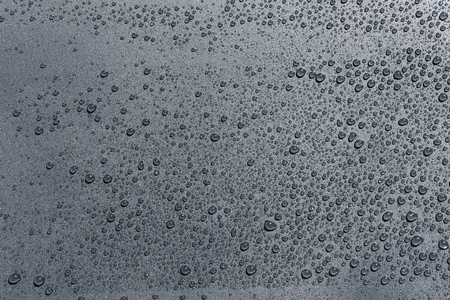 Water drops on a rough surface, texture backgroundの写真素材