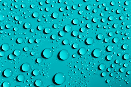Drops of water on azure color surface, abstract background
