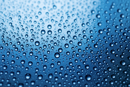 Drops of water on rough surface, blue abstract backgroundの写真素材