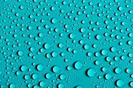 Drops of water on azure color surface, abstract backgroundの写真素材