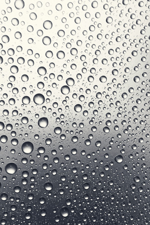 Drops of water on a metal surface, abstract backgroundの写真素材