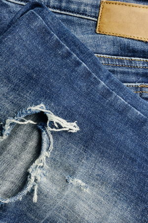 Close-up of a blue jean trousers, empty leather labelの写真素材