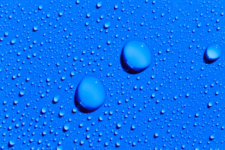 Drops of water on a blue color surface, abstract backgroundの写真素材