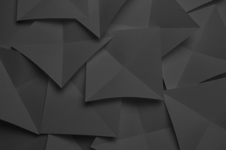 Overlapping geometric shapes of paper, dark backgroundの写真素材