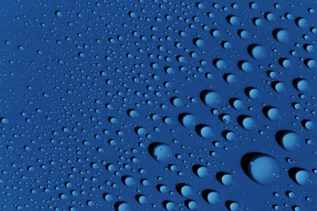 Rain drops on blue color surface; abstract backgroundの写真素材