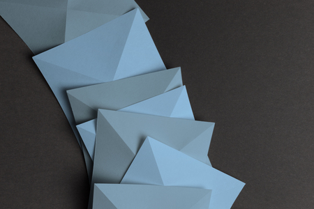 Overlapping geometric shapes of paper, isolated on grey backgroundの写真素材