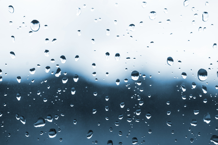 Raindrops on the glass, bad weather from the windowの写真素材