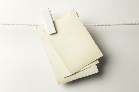 Vintage postcards hanging with clothespins, isolated on whiteの写真素材