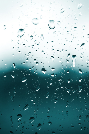 Raindrops on the glass, bad weather from the windowの写真素材