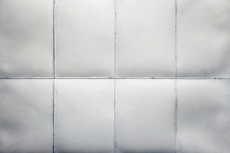 Empty sheet of paper folded in eight, white backgroundの写真素材