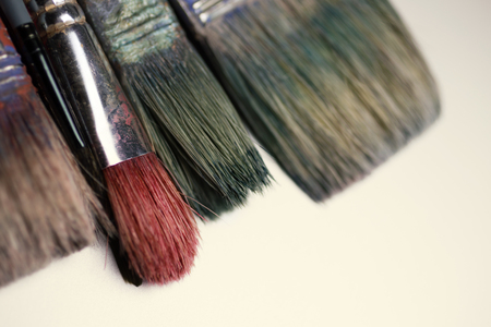 Old paint brushes isolated on white backgroundの写真素材