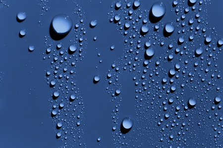Raindrops on blue surface, abstract backgroundの写真素材