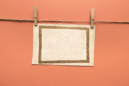 Cards hanging with wooden clothespinsの写真素材