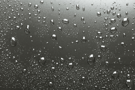 Metal surface with drops of water, silvery backgroundの写真素材