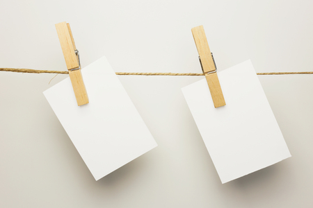 Paper cards hanging on a clothesline with clothespinsの写真素材