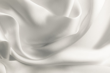 Elegant white satin silk with waves, abstract backgroundの写真素材