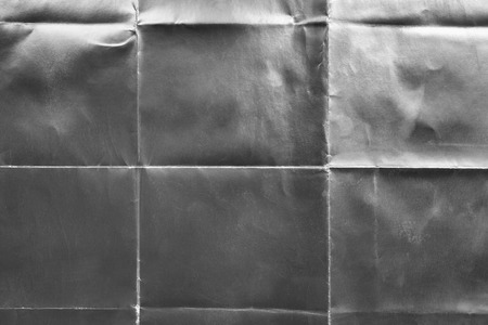 Old silver gift card with scratches and folds, texture backgroundの写真素材