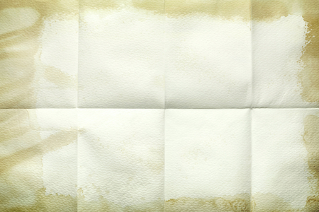 Empty sheet folded in eight, old paper with stained edgesの写真素材