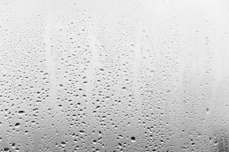 Raindrops on the window glass, gray backgroundの写真素材