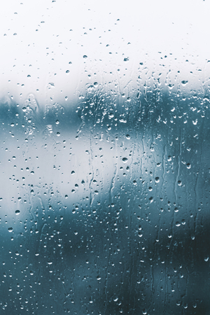 Raindrops on the window glass, blue backgroundの写真素材