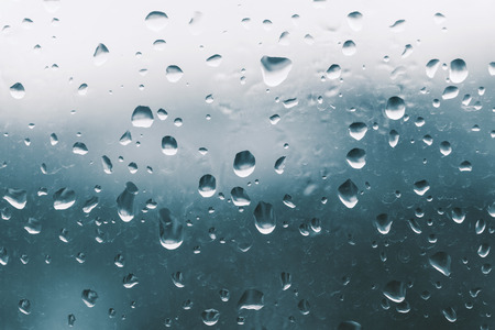Raindrops on the window glass, blue backgroundの写真素材