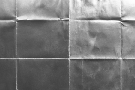 Old silver gift card with scratches and folds, texture backgroundの写真素材