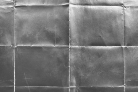Old silver gift card with scratches and folds, texture backgroundの写真素材