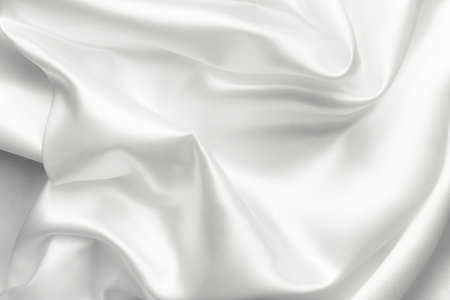 Elegant white satin silk with waves, abstract backgroundの写真素材