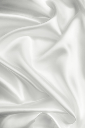 Elegant white satin silk with waves, abstract backgroundの写真素材