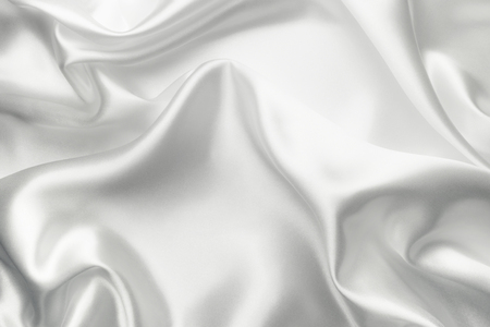 Elegant white satin silk with waves, abstract backgroundの写真素材
