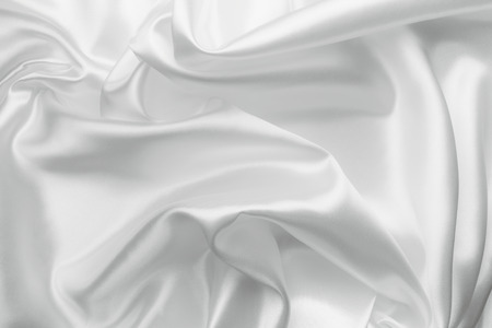 Elegant white satin silk with waves, abstract backgroundの写真素材