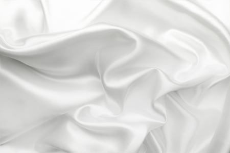 Elegant white satin silk with waves, abstract backgroundの写真素材