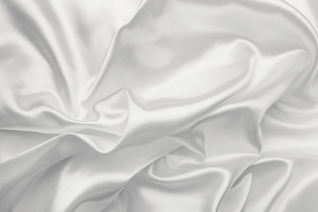 Elegant white satin silk with waves, abstract backgroundの写真素材