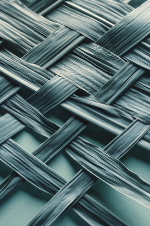 Texture of braided bamboo leaves, natural blue backgroundの写真素材