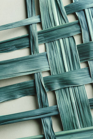 Texture of braided bamboo leaves, natural blue backgroundの写真素材
