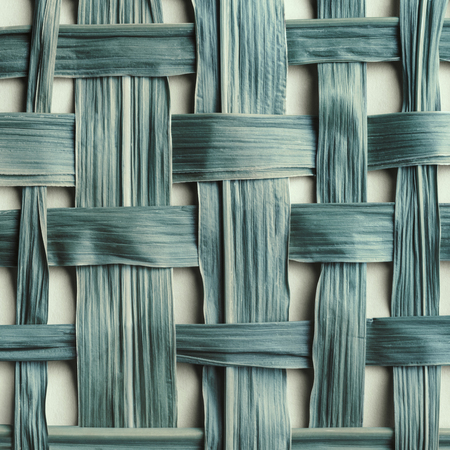 Texture of braided bamboo leaves, natural blue background