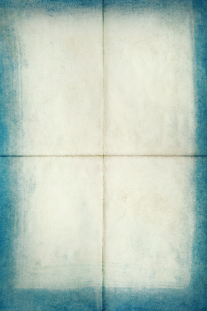 Blank old letter folded in four with blue edges, texture backgroundの写真素材