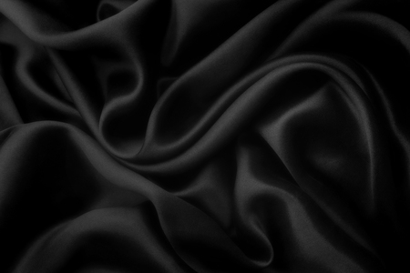 Elegant black satin silk with waves, abstract backgroundの写真素材