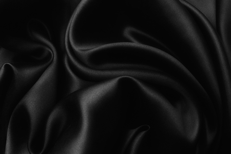 Elegant black satin silk with waves, texture backgroundの写真素材