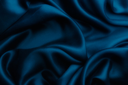 Elegant blue satin silk with waves, texture backgroundの写真素材