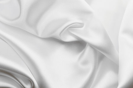 Elegant white satin silk with waves, texture backgroundの写真素材