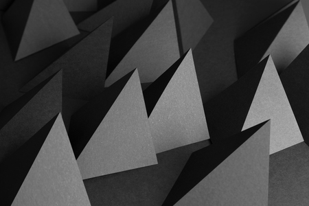 Composition with pyramids of paper, dark abstract backgroundの写真素材