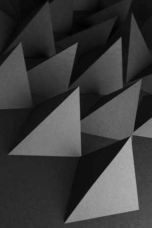 Composition with pyramidal shapes of paper, dark abstract backgroundの写真素材