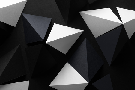 Geometric shapes of paper, white and black, dark abstract backgroundの写真素材