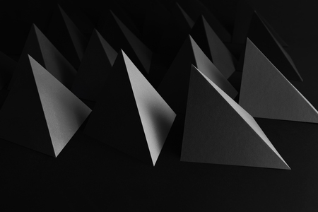 Creative image with triangular elements, black pyramids for abstract backgroundの写真素材