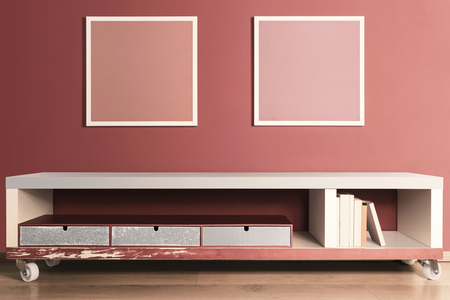 Interior, console with drawers and books, pictures on red wallの写真素材