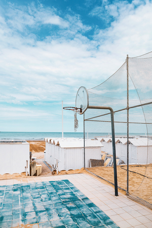 Beach playground, old basketball board, sea viewの写真素材