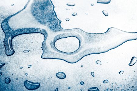 Water drops on rough silvery background, close-upの写真素材