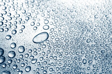 Water drops on rough silvery background, close-upの写真素材