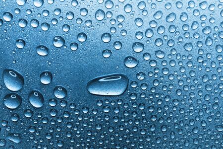 Water drops on rough silvery background, close-upの写真素材